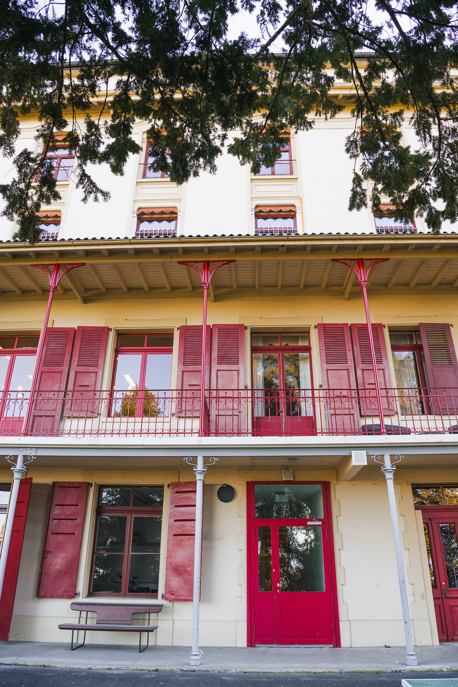 Red shutters and balconies on the campus façade